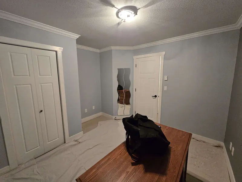 Interior painting, a light blue room with white doors